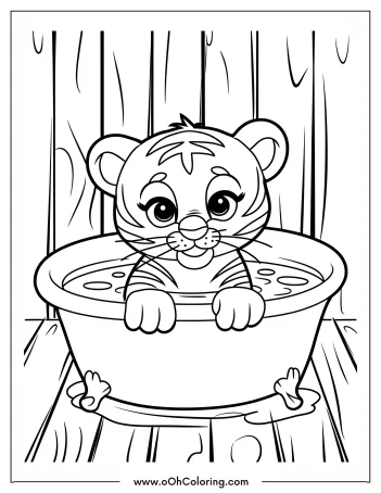 A cute tiger cub sitting in a tub, smiling brightly.